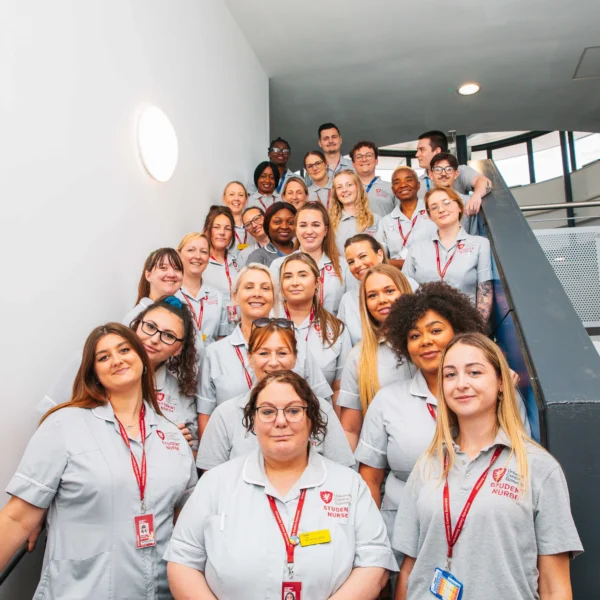 Group of people posing on a staircase.