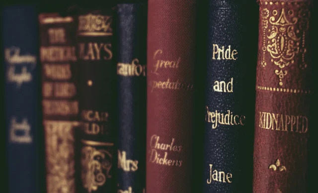 A close-up view of six classic literature book spines including Pride and Prejudice.