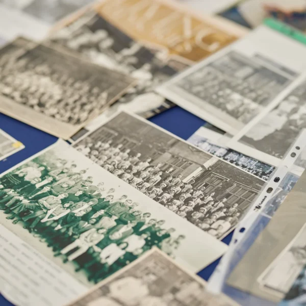 Vintage photographs arranged on a blue surface.