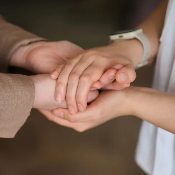 A couple holding hands, showing intimate connection and support.