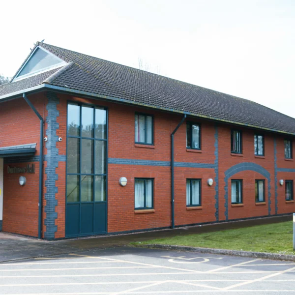 A red brick office building with blue trim and a grey roof