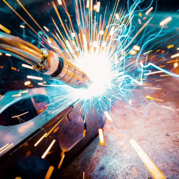 A close-up view of a welding process with sparks flying around.