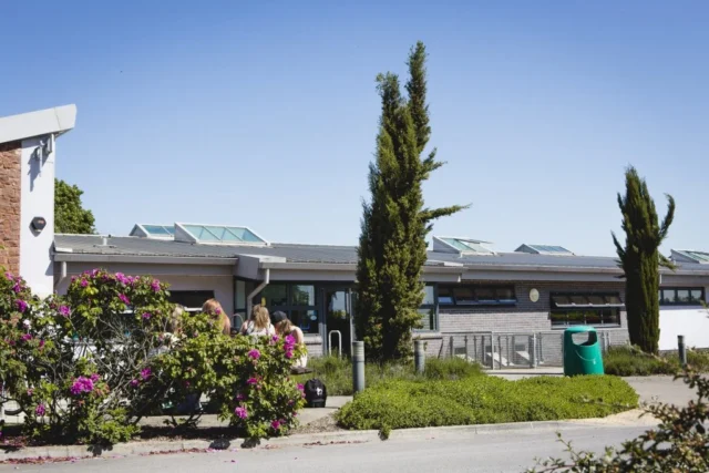 Modern building with solar panels and garden