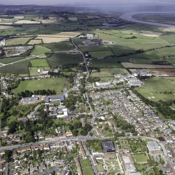 aerial view of a town with fields and a river