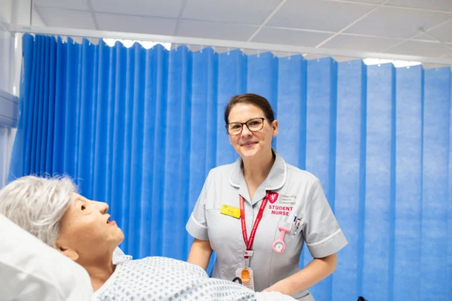Nurse attending to a patient in a hospital setting.