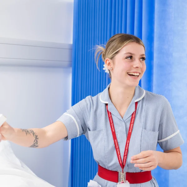 Nurse making a bed in a hospital room