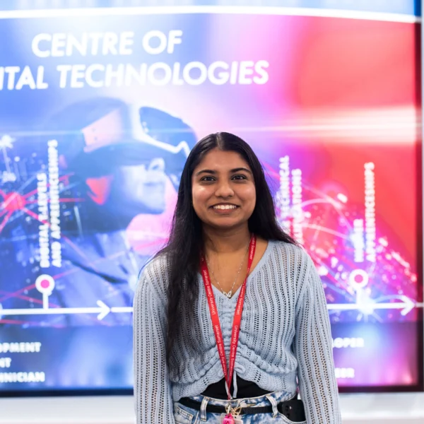 A woman standing in front of a screen with a Centre of Digital Technologies graphic.
