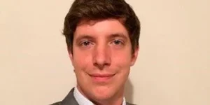 A young man with short brown hair smiling at the camera.