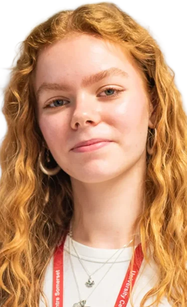 a young woman with long wavy red hair and a white shirt