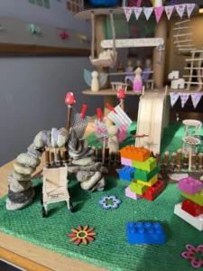 a child's play area with a green mat and toys