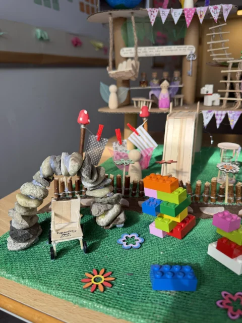 a child's play area with a green mat and toys