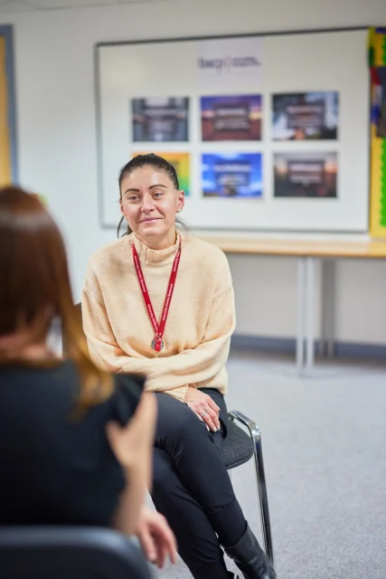 Woman sitting and talking to another woman