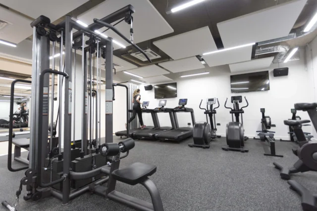 A well-equipped gym with various exercise machines.