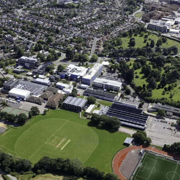 An aerial view of a school campus with sports fields and buildings.