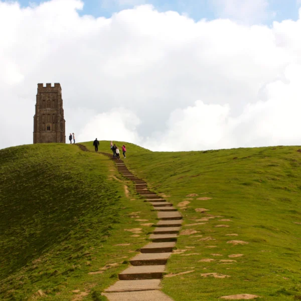 St Michael's Tower on Glastonbury Tor with a set of stairs leading up to it.