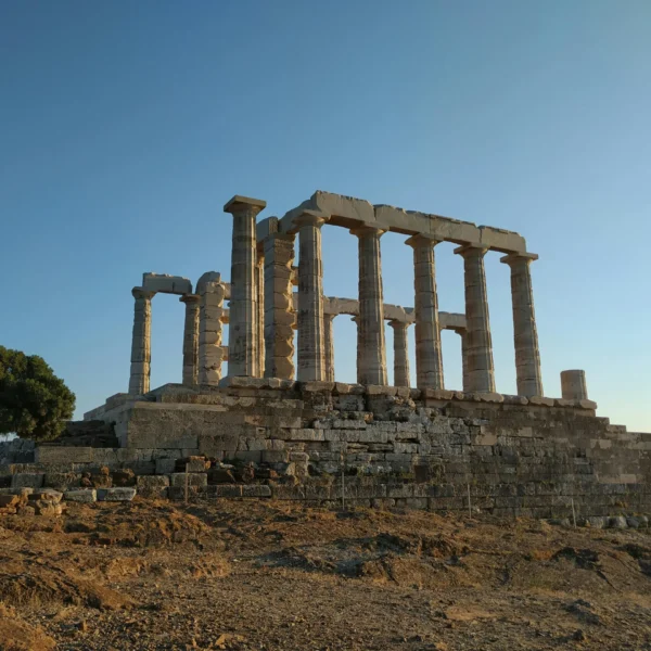 The Temple of Poseidon at sunset, with columns standing tall on a hill.