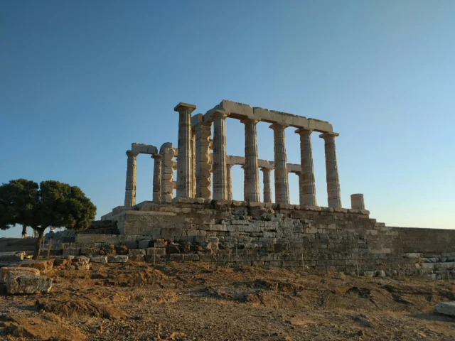 The Temple of Poseidon at sunset, with columns standing tall on a hill.