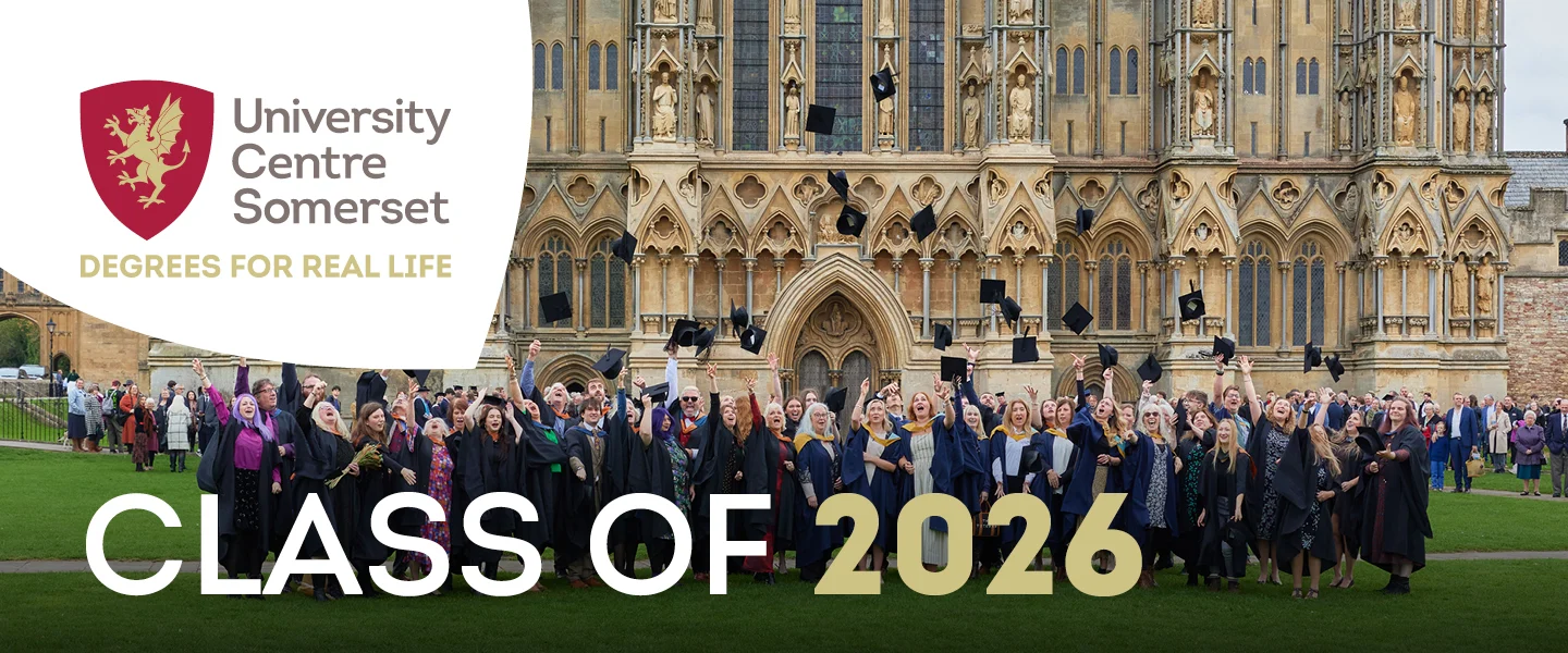 University Centre Somerset graduates in academic regalia standing in front of a historic building