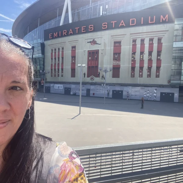 Dr Louise Hannan taking a selfie in front of the Emirates Stadium in London.