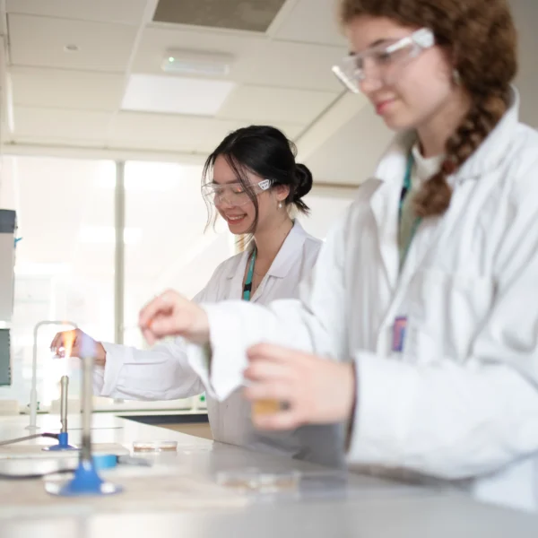 Two female scientists in lab coats working in a laboratory.