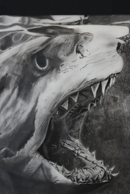 A shark with its mouth wide open and sharp teeth visible.