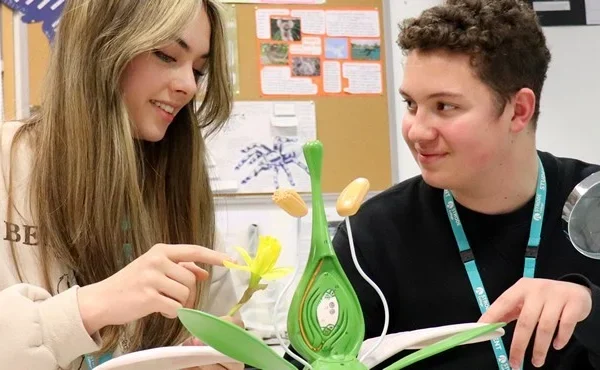 two students looking at a book