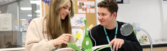 two students looking at a book
