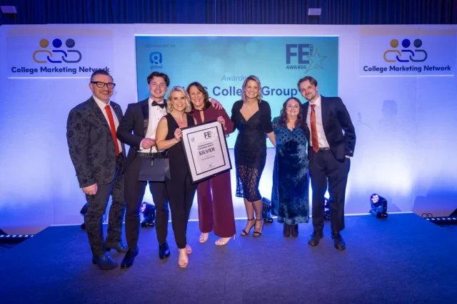Group of people on stage with a certificate