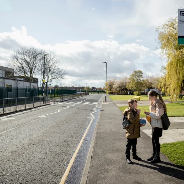 Mother and son at a bus stop