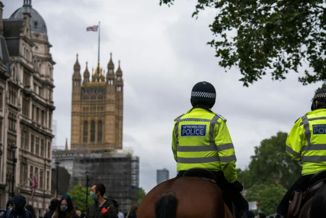 Police on horseback in front of the Houses of Parliament