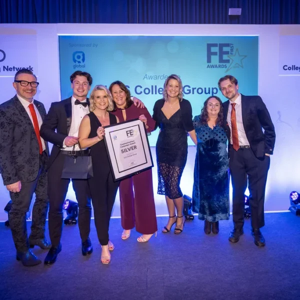 Group of people on stage with a certificate