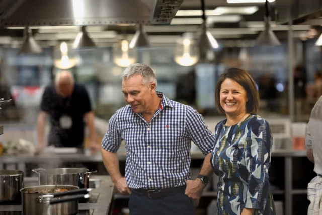 Man and woman standing in a kitchen